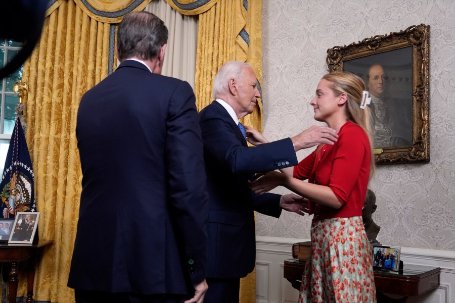 President Joe Biden hugs his granddaughter Finnegan Biden as Hunter Biden watches after addressing the nation from the Oval Office of the White House in Washington, Wednesday, July 24, 2024, about his decision to drop his Democratic presidential reelection bid. (AP Photo/Evan Vucci, Pool)