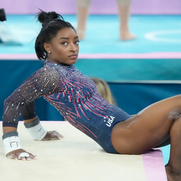 Simone Biles of the United States watches her teammates during a gymnastics training session at Bercy Arena at the 2024 Summer Olympics, Thursday, July 25, 2024, in Paris, France. (AP Photo/Charlie Riedel)