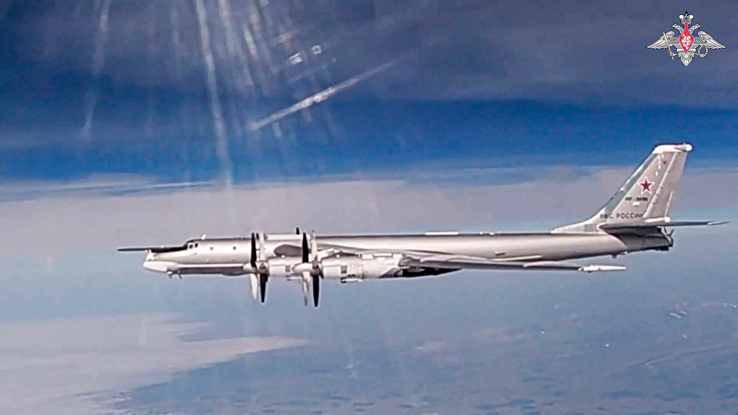 In this photo taken from video released by Russian Defense Ministry Press Service on Thursday, July 25, 2024, A Tu-95 strategic bomber of the Russian air force is seen during a joint Russia-China air patrol. (Russian Defense Ministry Press Service via AP)