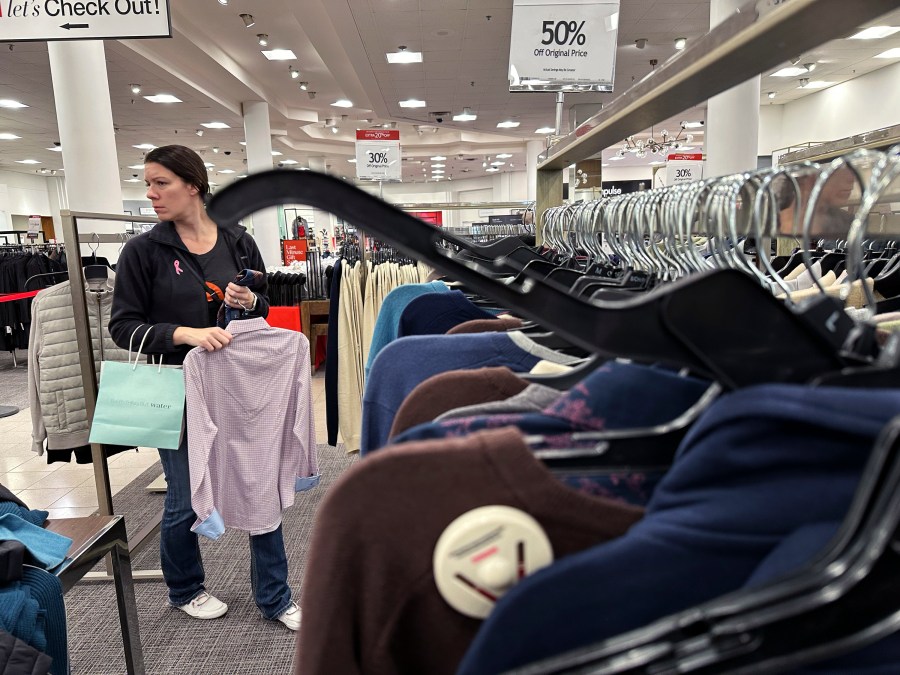 FILE - A woman shops at a retail store in Schaumburg, Ill., Dec. 18, 2023. On Friday, June 26, 2024, the Commerce Department issues its report on consumer spending for June. (AP Photo/Nam Y. Huh, File)