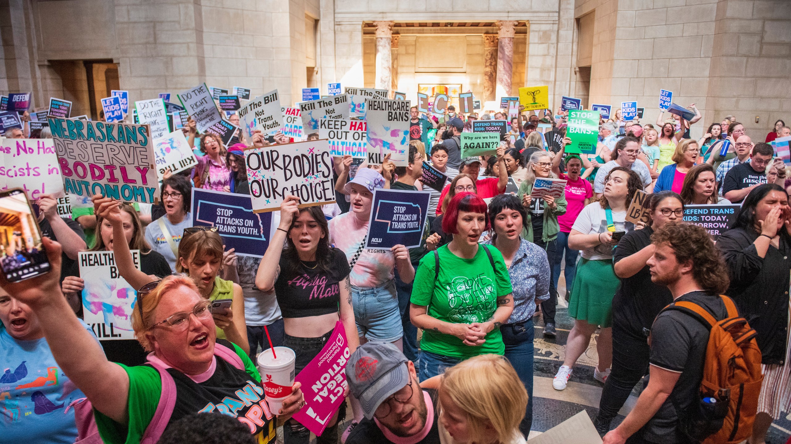 FILE - Protesters chant as they are heard in the legislative chamber during a final reading on a bill that combined a 12-week abortion ban with a measure to restrict gender-affirming care for people under 19, May 16, 2023, at state Capitol in Lincoln, Neb. A Nebraska law that combined abortion restrictions with another measure to limit gender-affirming health care for minors does not violate a state constitutional amendment requiring bills to stick to a single subject, the Nebraska Supreme Court ruled Friday, July 26, 2024.(Kenneth Ferriera/Lincoln Journal Star via AP)