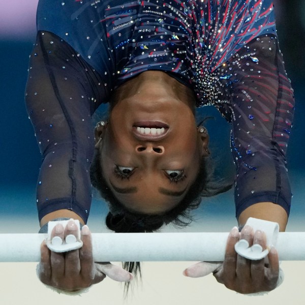 Simone Biles of the United States practices the uneven bars during a gymnastics training session at Bercy Arena at the 2024 Summer Olympics, Thursday, July 25, 2024, in Paris, France. (AP Photo/Charlie Riedel)