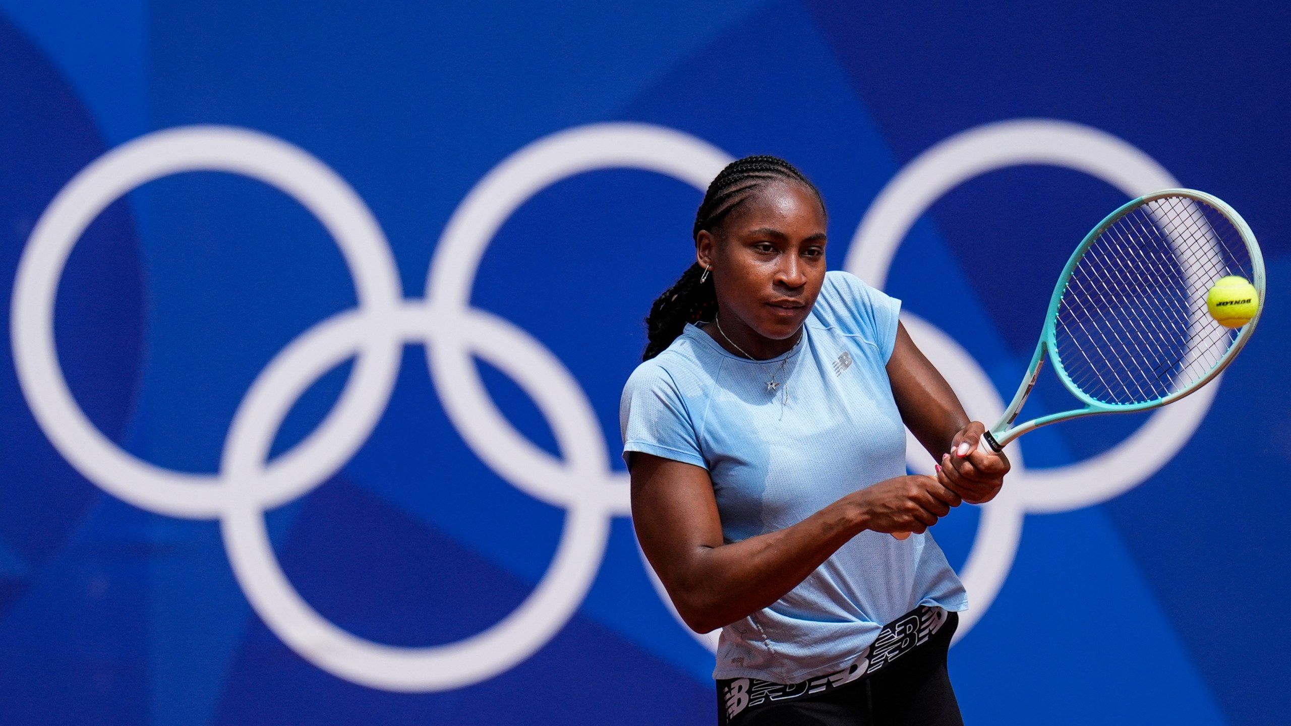Coco Gauff of the U.S. returns the ball during a practice session ahead of the tennis competition, at the 2024 Summer Olympics, Thursday, July 25, 2024, in Paris, France. (AP Photo/Manu Fernandez)