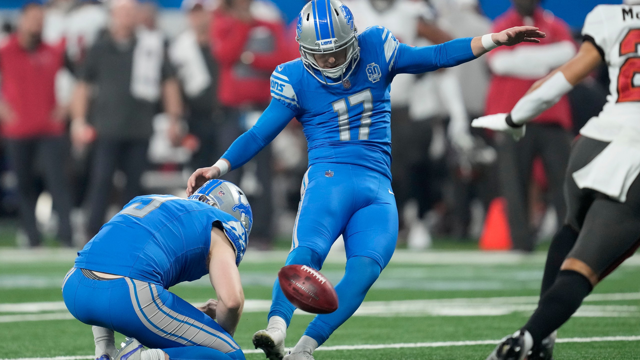 FILE - Detroit Lions place kicker Michael Badgley (17), with Jack Fox holding, kicks a field goal against the Tampa Bay Buccaneers during the first half of an NFL football NFC divisional playoff game, Sunday, Jan. 21, 2024, in Detroit. Badgley was injured before practice Thursday, July 26, 2204, and will require surgery. Coach Dan Campbell didn’t disclose the nature of the injury. (AP Photo/Paul Sancya, File)