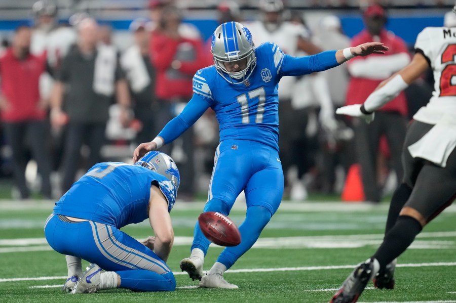 FILE - Detroit Lions place kicker Michael Badgley (17), with Jack Fox holding, kicks a field goal against the Tampa Bay Buccaneers during the first half of an NFL football NFC divisional playoff game, Sunday, Jan. 21, 2024, in Detroit. Badgley was injured before practice Thursday, July 26, 2204, and will require surgery. Coach Dan Campbell didn’t disclose the nature of the injury. (AP Photo/Paul Sancya, File)