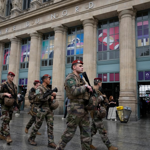 Soldiers patrol outside Gare du Nord train station at the 2024 Summer Olympics, Friday, July 26, 2024, in Paris, France. Hours away from the grand opening ceremony of the Olympics, high-speed rail traffic to the French capital was severely disrupted on Friday by what officials described as "criminal actions" and sabotage. (AP Photo/Mark Baker)