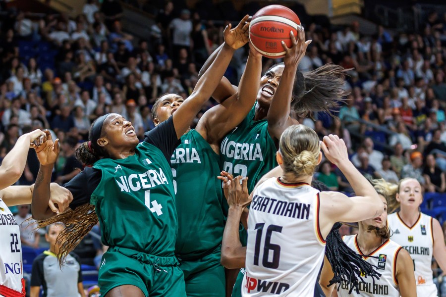 Germany's Alina Hartmann, right, tries to get the ball against, from right, Blessing Ejiofor, Lauren Ebo and Elizabeth Balogun from Nigeria during the Women International Basketball match between Germany and Nigeria at the Uber Arena in Berlin, Friday July 19, 2024. (Andreas Gora/dpa via AP)