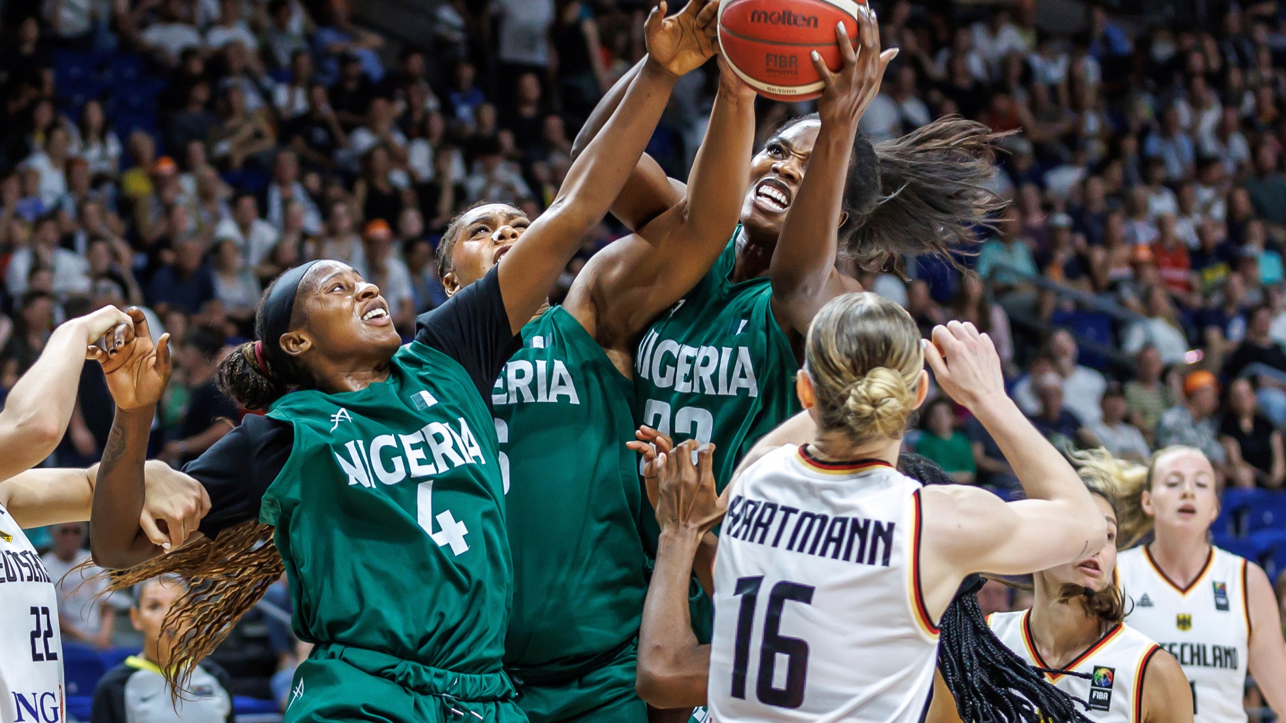 Germany's Alina Hartmann, right, tries to get the ball against, from right, Blessing Ejiofor, Lauren Ebo and Elizabeth Balogun from Nigeria during the Women International Basketball match between Germany and Nigeria at the Uber Arena in Berlin, Friday July 19, 2024. (Andreas Gora/dpa via AP)