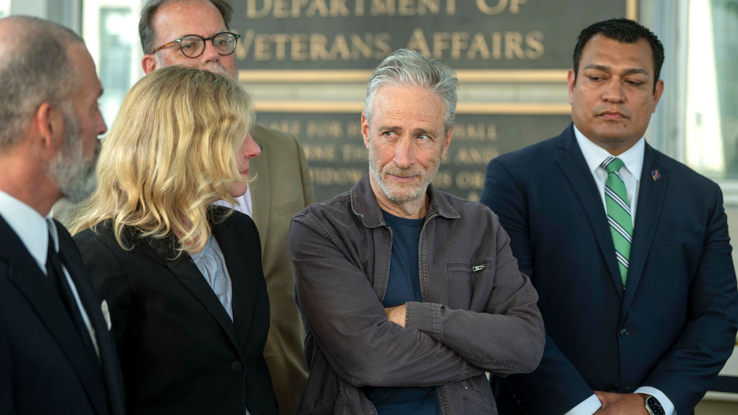 Jon Stewart, second from right, takes part in an interview following meetings with the Department of Veterans Affairs on Friday, July 26, 2024, in Washington. (AP Photo/Kevin Wolf)