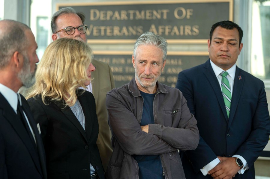 Jon Stewart, second from right, takes part in an interview following meetings with the Department of Veterans Affairs on Friday, July 26, 2024, in Washington. (AP Photo/Kevin Wolf)