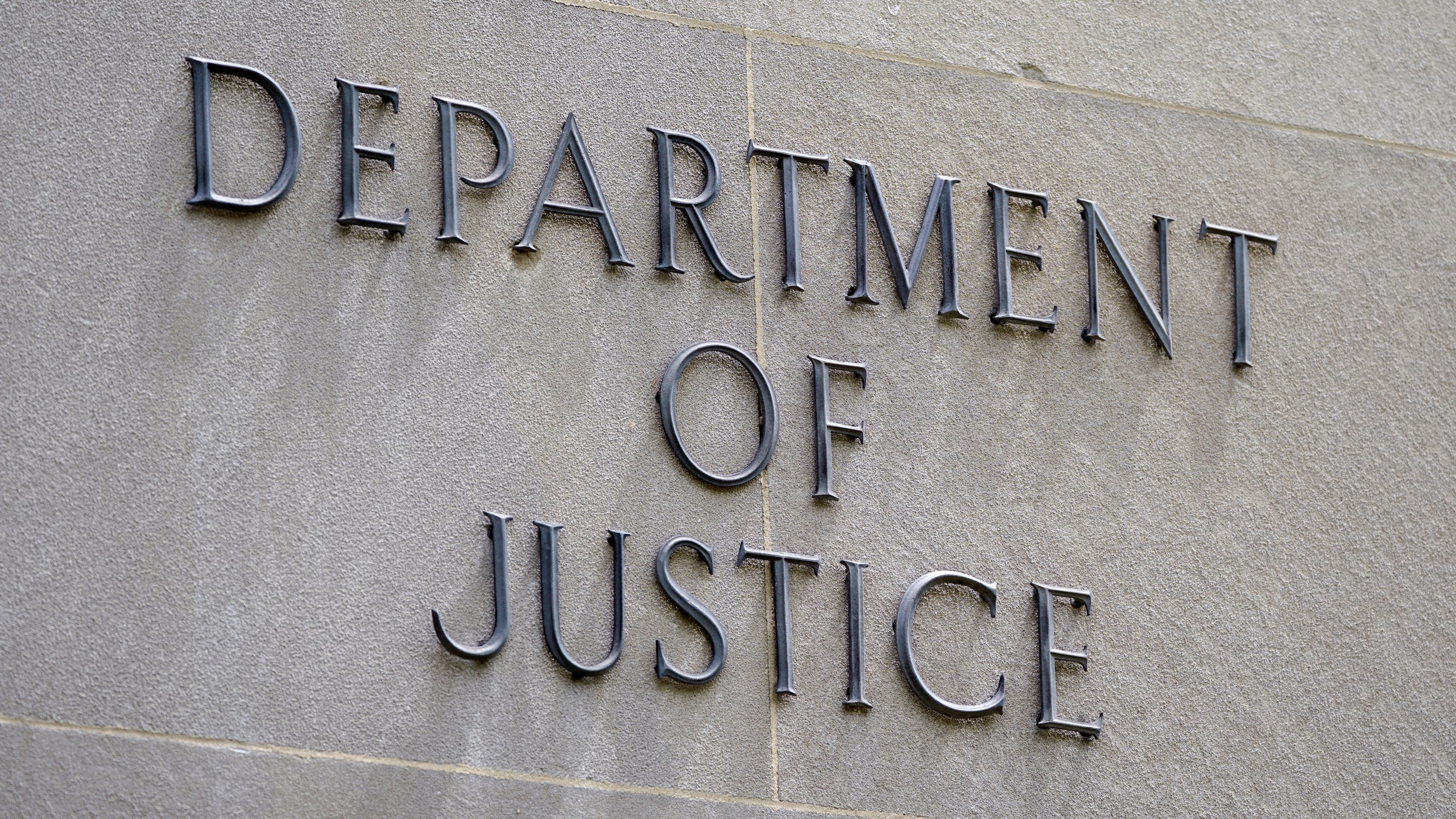 FILE - A sign outside the Robert F. Kennedy Department of Justice building is seen in Washington, May 4, 2021.