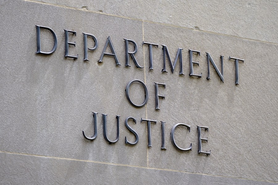 FILE - A sign outside the Robert F. Kennedy Department of Justice building is seen in Washington, May 4, 2021.