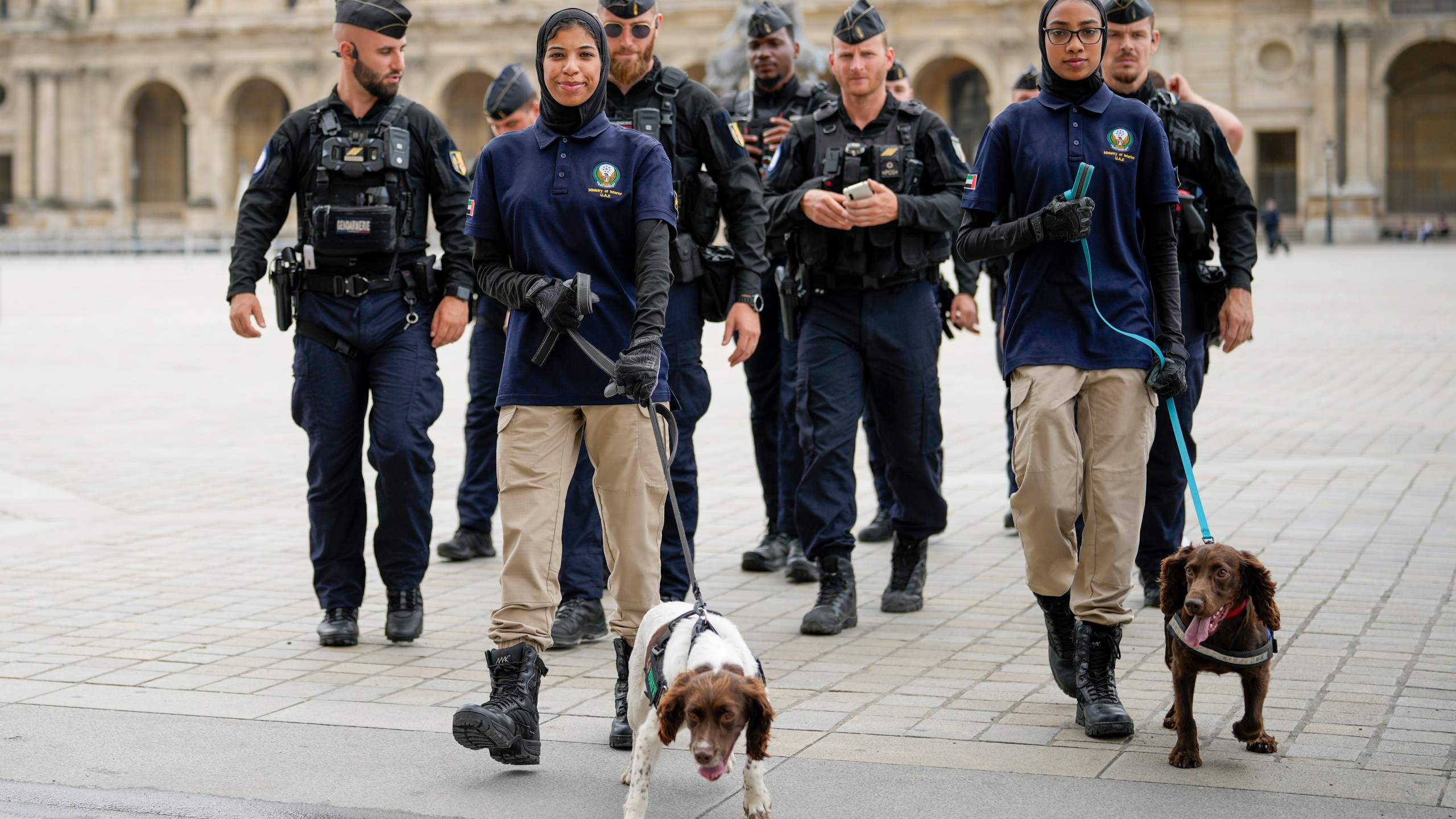 Members of the United Arab Emirates security team and French police patrol a square near the Louvre in Paris, France, ahead of the opening ceremony of the 2024 Summer Olympics, Friday, July 26, 2024. (AP Photo/Ebrahim Noroozi)