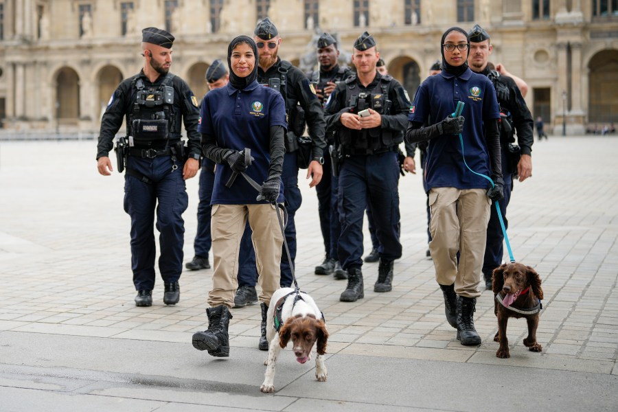 Members of the United Arab Emirates security team and French police patrol a square near the Louvre in Paris, France, ahead of the opening ceremony of the 2024 Summer Olympics, Friday, July 26, 2024. (AP Photo/Ebrahim Noroozi)