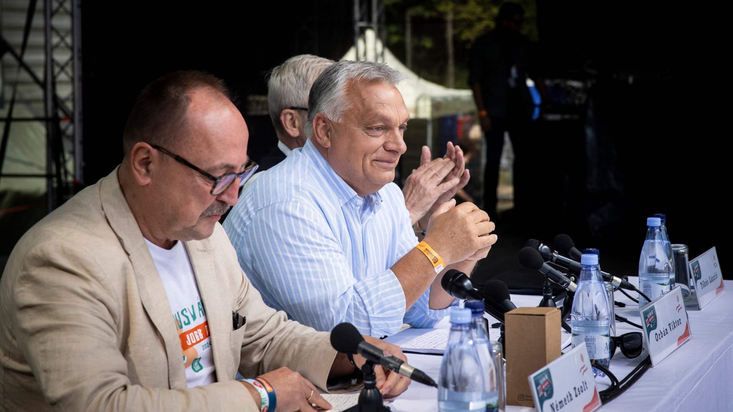 In this picture issued by the Hungarian PM's Press Office, Chairman of the Foreign Committee of the Hungarian Parliament Zsolt Nemeth, left, Hungarian Prime Minister Viktor Orban, center, and President of the Hungarian National Council of Transylvania Laszlo Tokes attend the 33th Balvanyos Summer University and Students' Camp in Baile Tusnad, Transylvania, Romania, Saturday, July 27, 2024. (Zoltan Fischer/Hungarian PM's Press Office/MTI via AP)