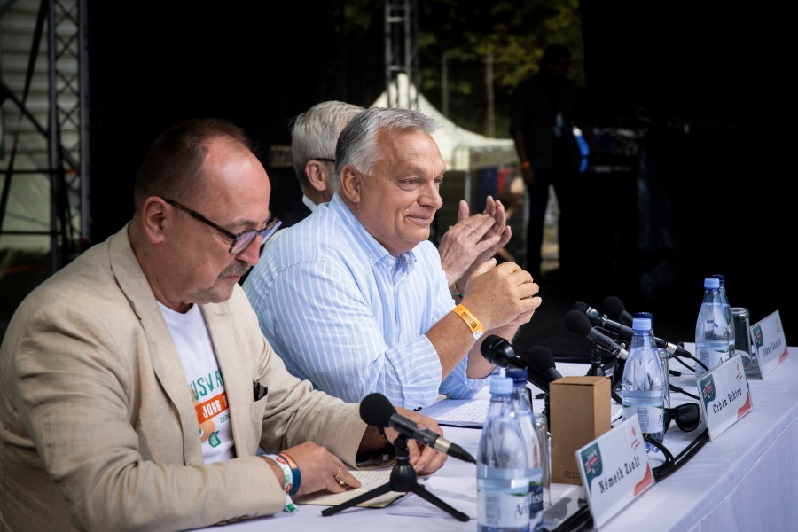 In this picture issued by the Hungarian PM's Press Office, Chairman of the Foreign Committee of the Hungarian Parliament Zsolt Nemeth, left, Hungarian Prime Minister Viktor Orban, center, and President of the Hungarian National Council of Transylvania Laszlo Tokes attend the 33th Balvanyos Summer University and Students' Camp in Baile Tusnad, Transylvania, Romania, Saturday, July 27, 2024. (Zoltan Fischer/Hungarian PM's Press Office/MTI via AP)