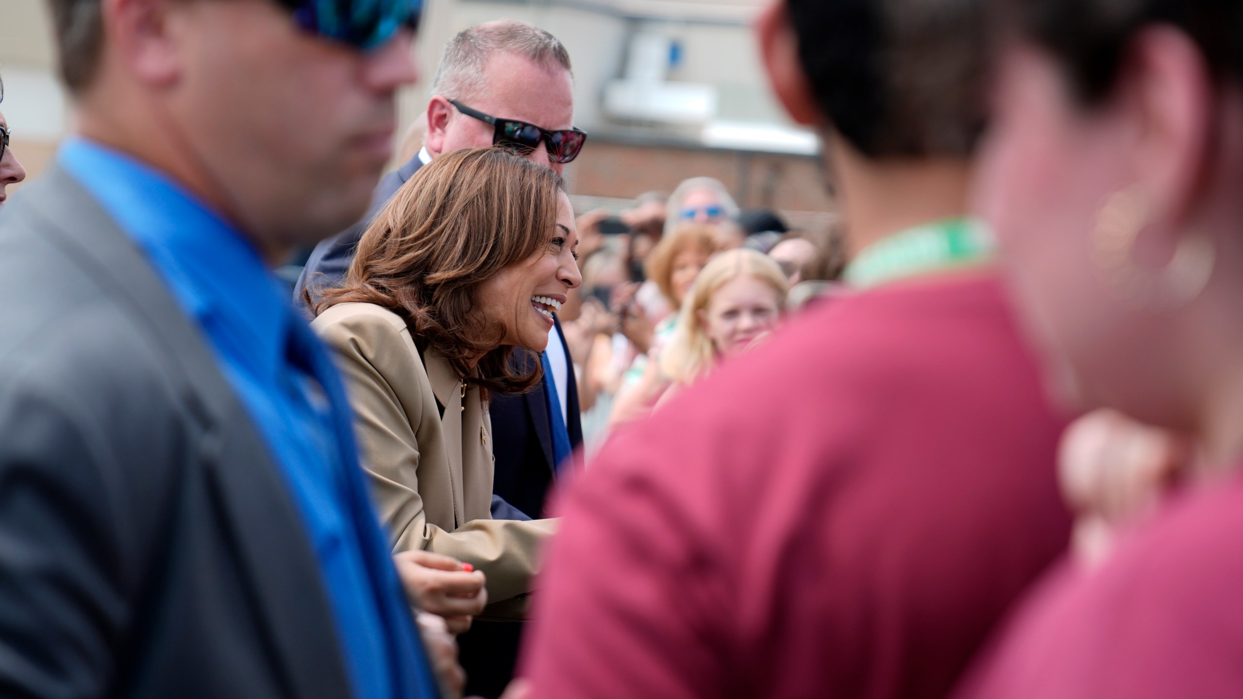 Vice President Kamala Harris greets supporters as she arrives at Westfield-Barnes Regional Airport in Westfield, Mass., Saturday, July 27, 2024. Harris is traveling to Pittsfield, Mass., to participate in a political event. (AP Photo/Stephanie Scarbrough)