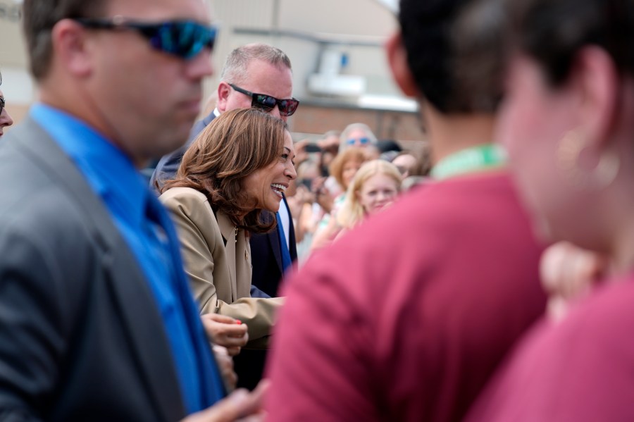 Vice President Kamala Harris greets supporters as she arrives at Westfield-Barnes Regional Airport in Westfield, Mass., Saturday, July 27, 2024. Harris is traveling to Pittsfield, Mass., to participate in a political event. (AP Photo/Stephanie Scarbrough)