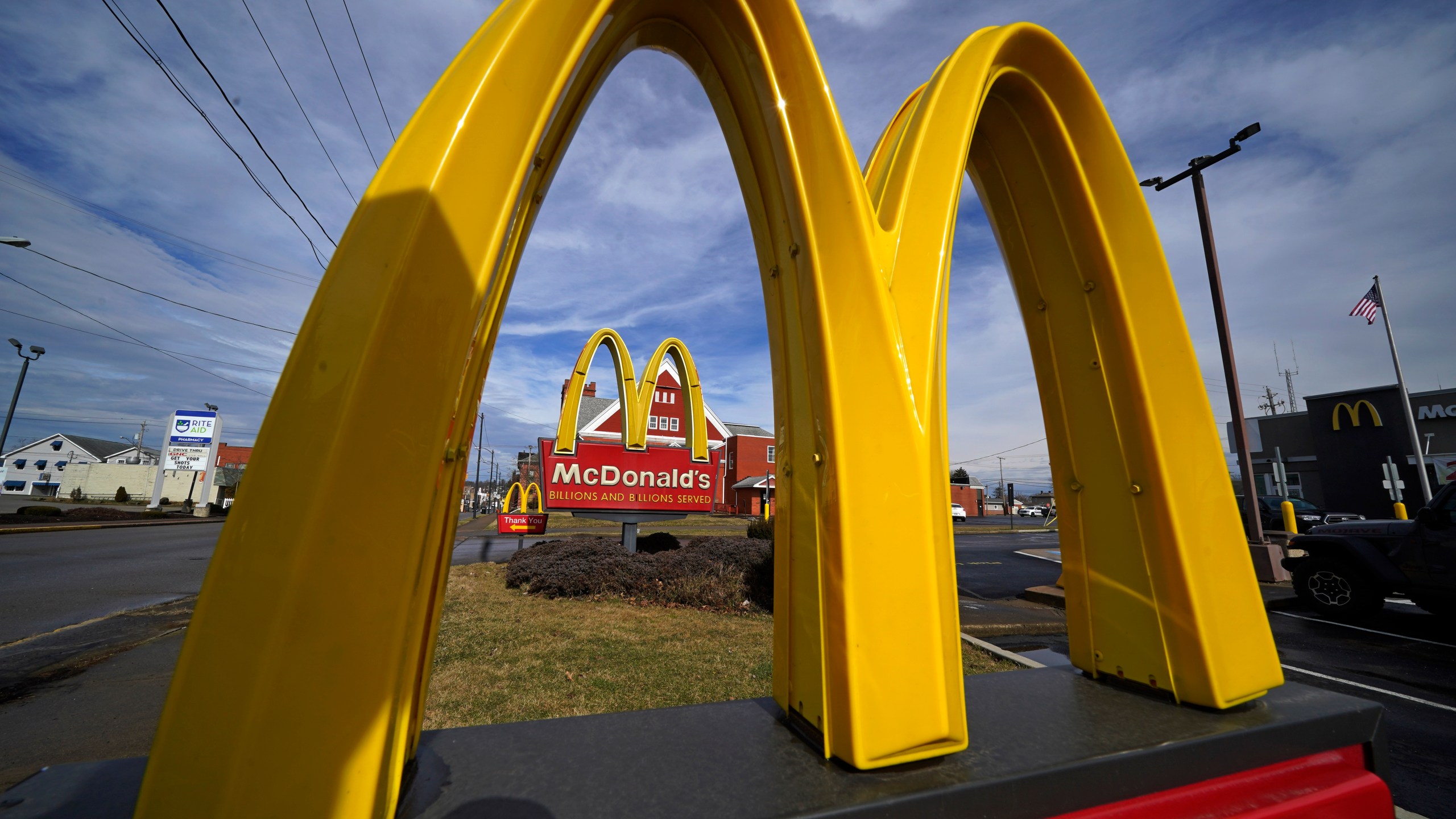 FILE - McDonald's restaurant signs are shown in in East Palestine, Ohio, Feb. 9, 2023. McDonald's reports earning on Monday, July 29, 2024.(AP Photo/Gene J. Puskar, File)