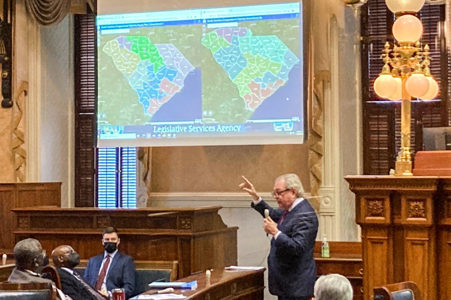 FILE - State Sen. Dick Harpootlian, D-Columbia, compares his proposed map of U.S. House districts drawn with 2020 U.S. Census data to a plan supported by Republicans on Jan. 20, 2022, in Columbia, S.C. A voting rights group sued South Carolina legislative leaders Monday, July 29, 2024, saying the maps they drew based on the 2020 Census lean too far toward Republicans. (AP Photo/Jeffrey Collins, File)