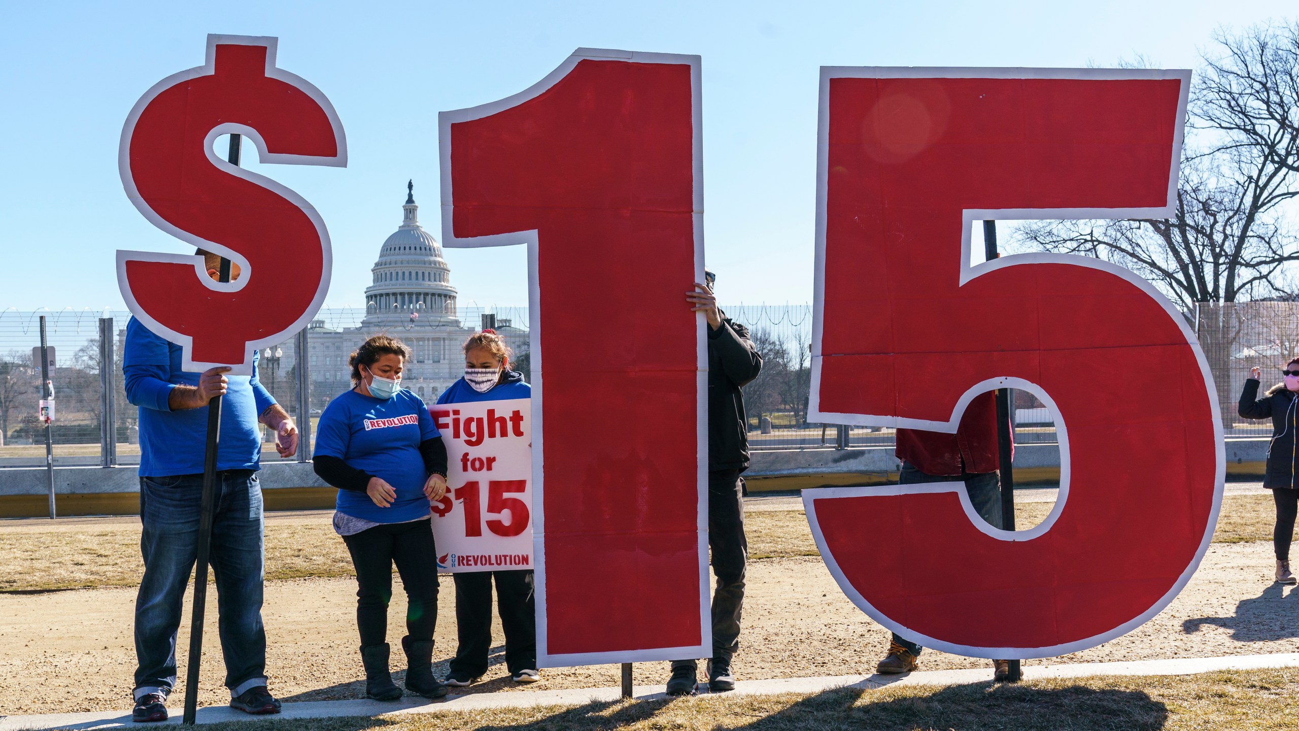 FILE - Activists appeal for a $15 minimum wage near the Capitol in Washington, Feb. 25, 2021. (AP Photo/J. Scott Applewhite, File)