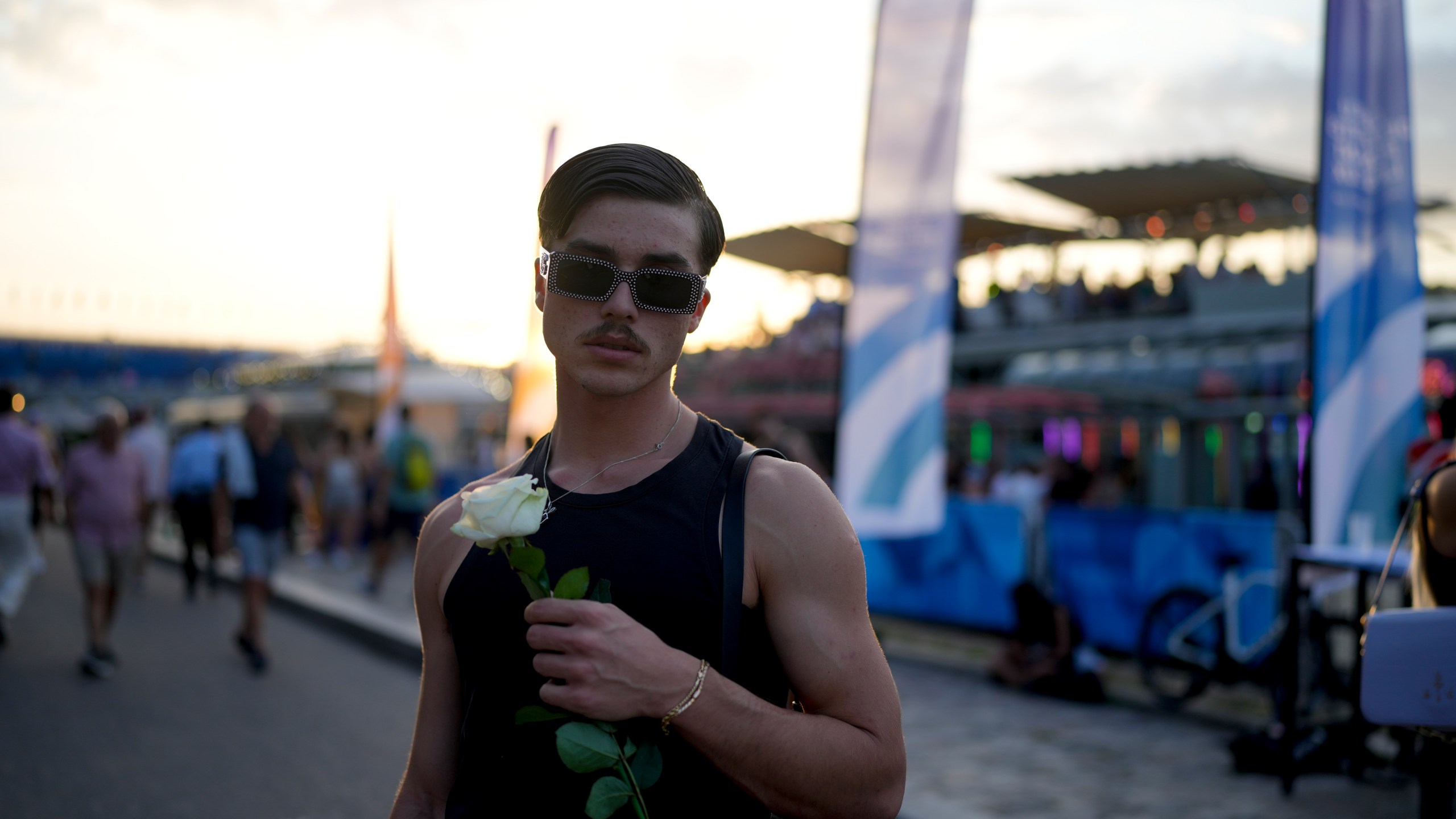 Robin Labarrere holds a flower after performing at the opening of Pride House, the safe space for the LGBT+ community of athletes, during the 2024 Summer Olympics, Monday, July 29, 2024, in Paris, France. (AP Photo/Natacha Pisarenko)