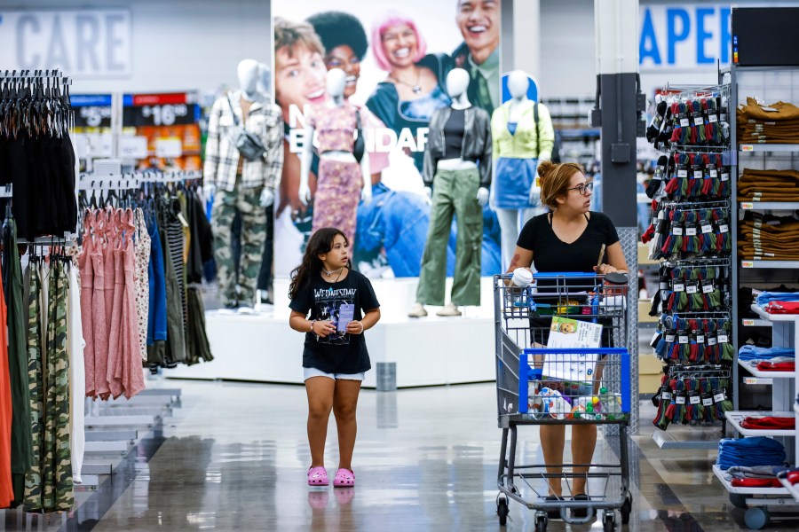 Shoppers pass clothing from Walmart's No Boundaries brand at a Walmart Superstore in Secaucus, New Jersey, Thursday, July 11, 2024. Walmart relaunched No Boundaries, its 30-year-old brand for teenagers and young adults, earlier this month with a new 130-piece fall collection. (AP Photo/Eduardo Munoz Alvarez)