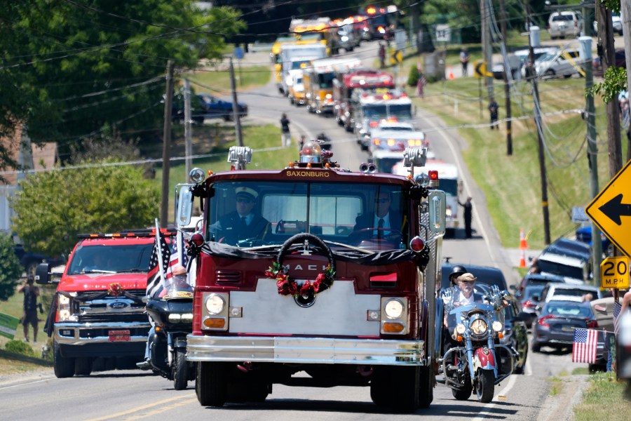 A Saxonburg, Pa. fire truck carrying the casket of Cory Comperatore, leads a procession of fire vehicles following a memorial service at Cabot United Methodist Church in Cabot, Pa., Friday, July 19, 2024. Comperatore, a former fire chief, was shot and killed at a rally where a gunman tried to assassinate former President Donald Trump. (AP Photo/Gene J. Puskar)