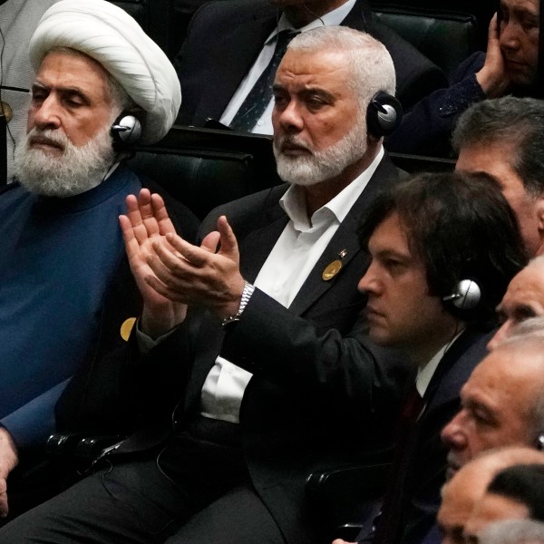 Hamas chief Ismail Haniyeh claps as newly-elected Iranian President Masoud Pezeshkian speaks while deputy leader of the Lebanese militant group Hezbollah, Sheikh Naim Kassem, left, sits during the swearing-in ceremony of Pezeshkian at the Iranian parliament, in Tehran, Iran, Tuesday, July 30, 2024. (AP Photo/Vahid Salemi)