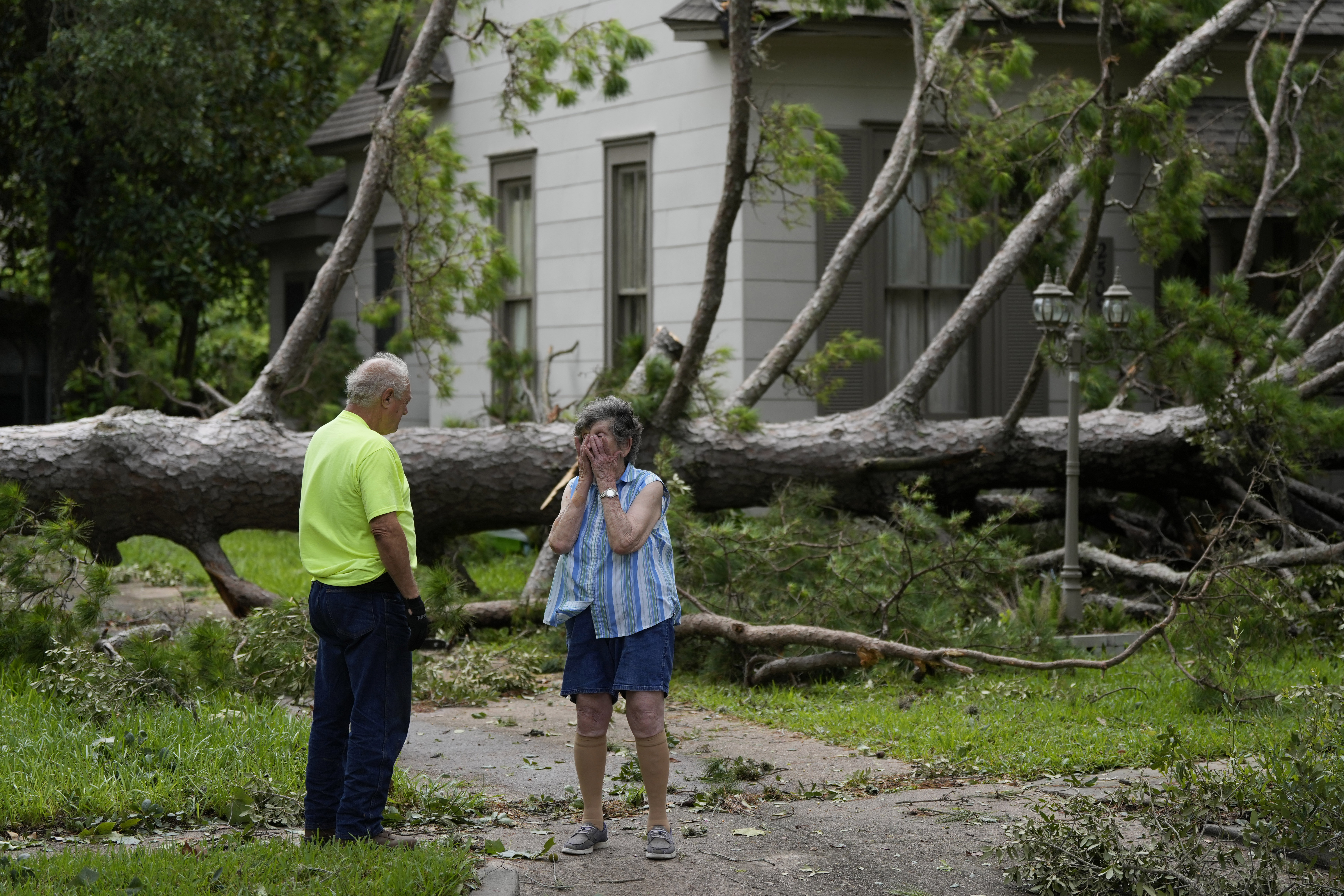 Jackie Jecmenek, right, talks with city worker Bobby Head as she stands in front of her neighbor's home after Beryl passed, Monday, July 8, 2024, in Bay City, Texas.