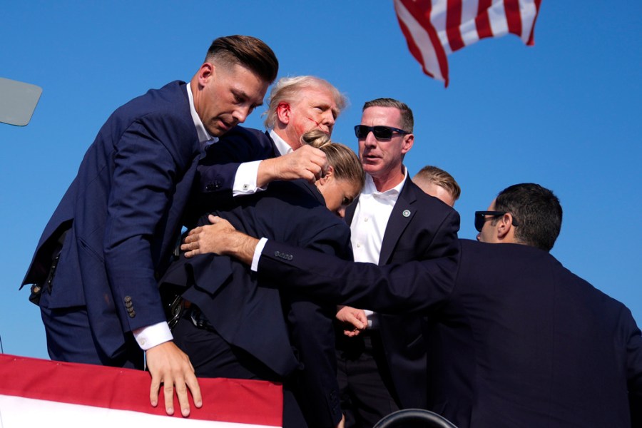 Republican presidential candidate former President Donald Trump is surrounded by U.S. Secret Service agents at a campaign rally, Saturday, July 13, 2024, in Butler, Pa. (AP Photo/Evan Vucci)