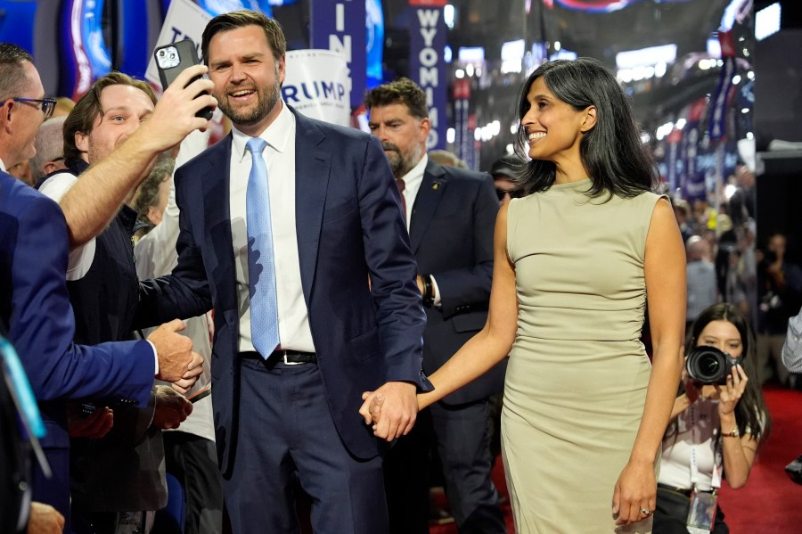 Republican VP candidate Sen. JD Vance and his wife Usha Chilukuri Vance arrive on the RNC floor.