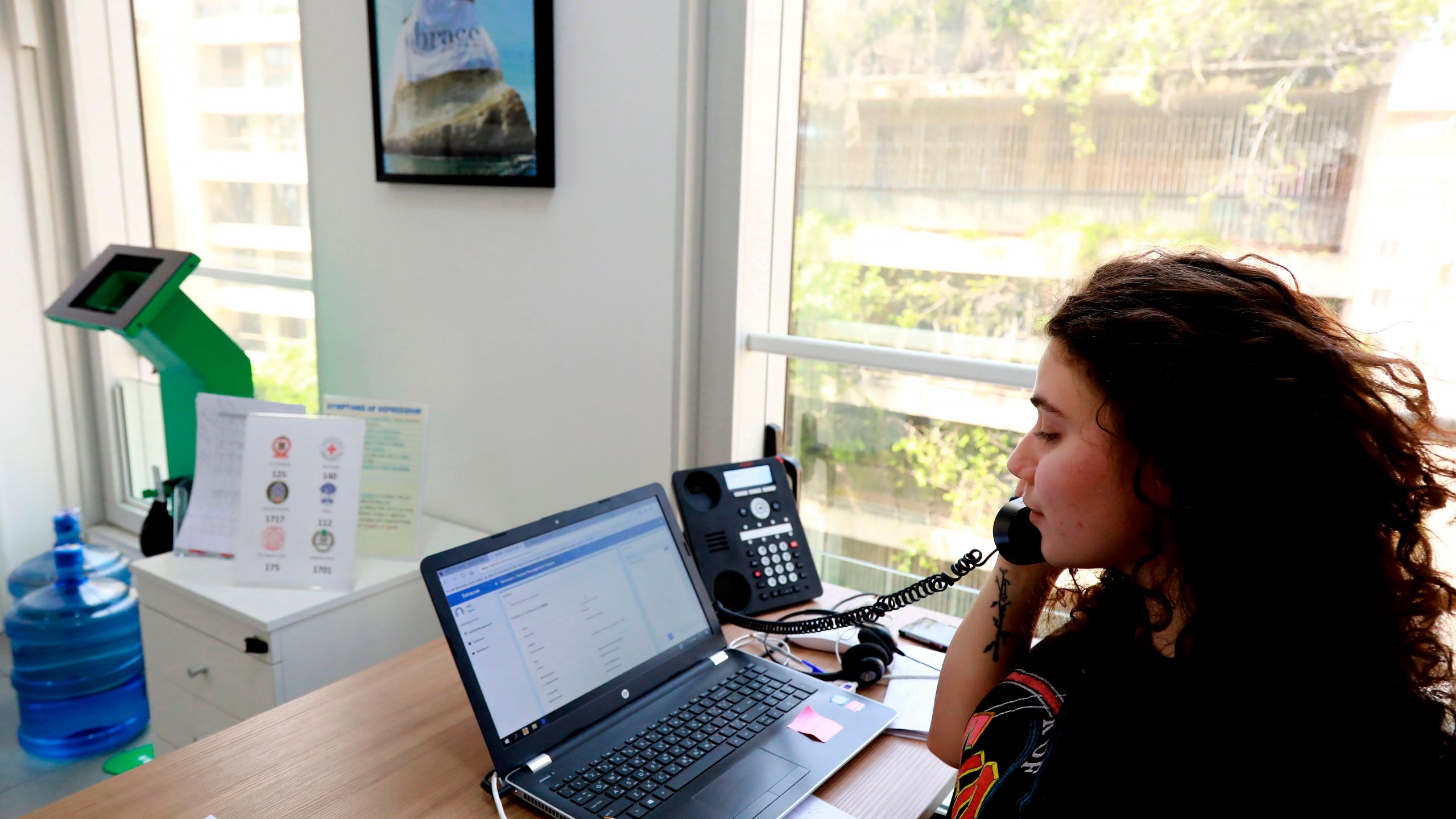 Sally, a volunteer, listens to a caller at Embrace, a suicide prevention helpline