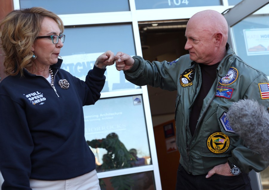 U.S. Sen. Mark Kelly fist bumps his wife, former Rep. Gabby Giffords.