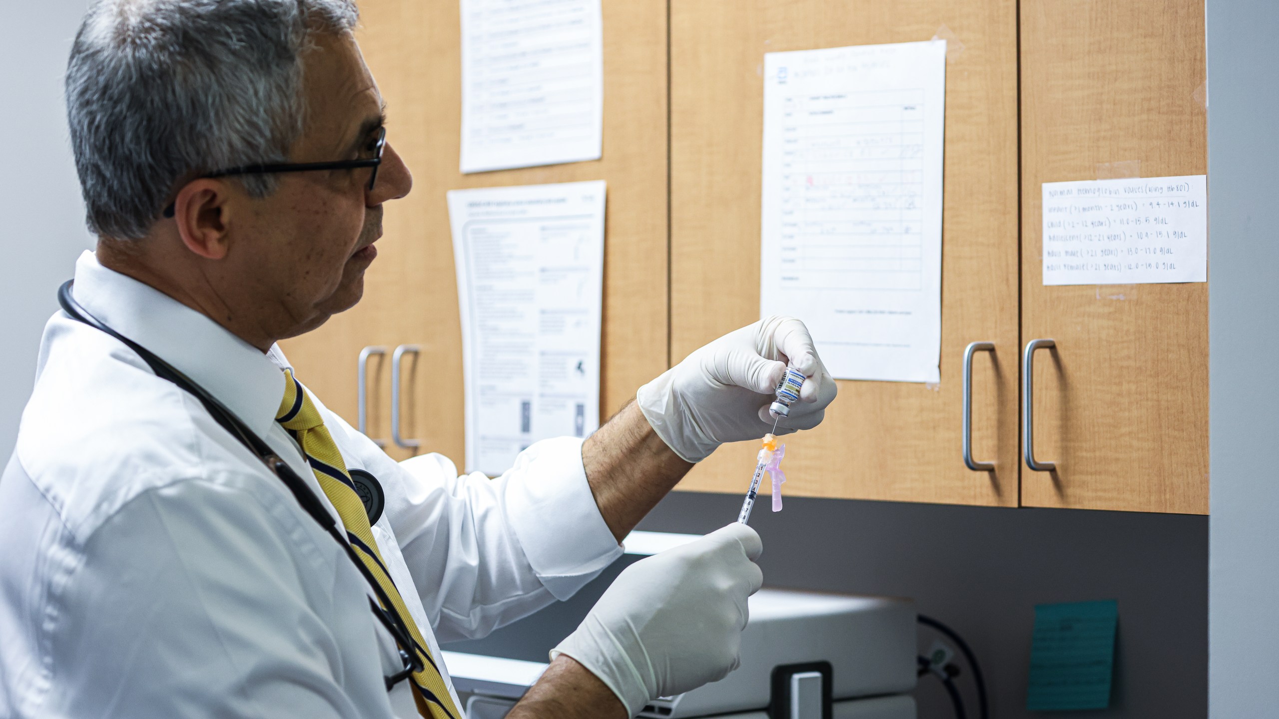 A doctor preparing a COVID vaccine