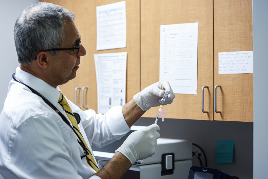 A doctor preparing a COVID vaccine