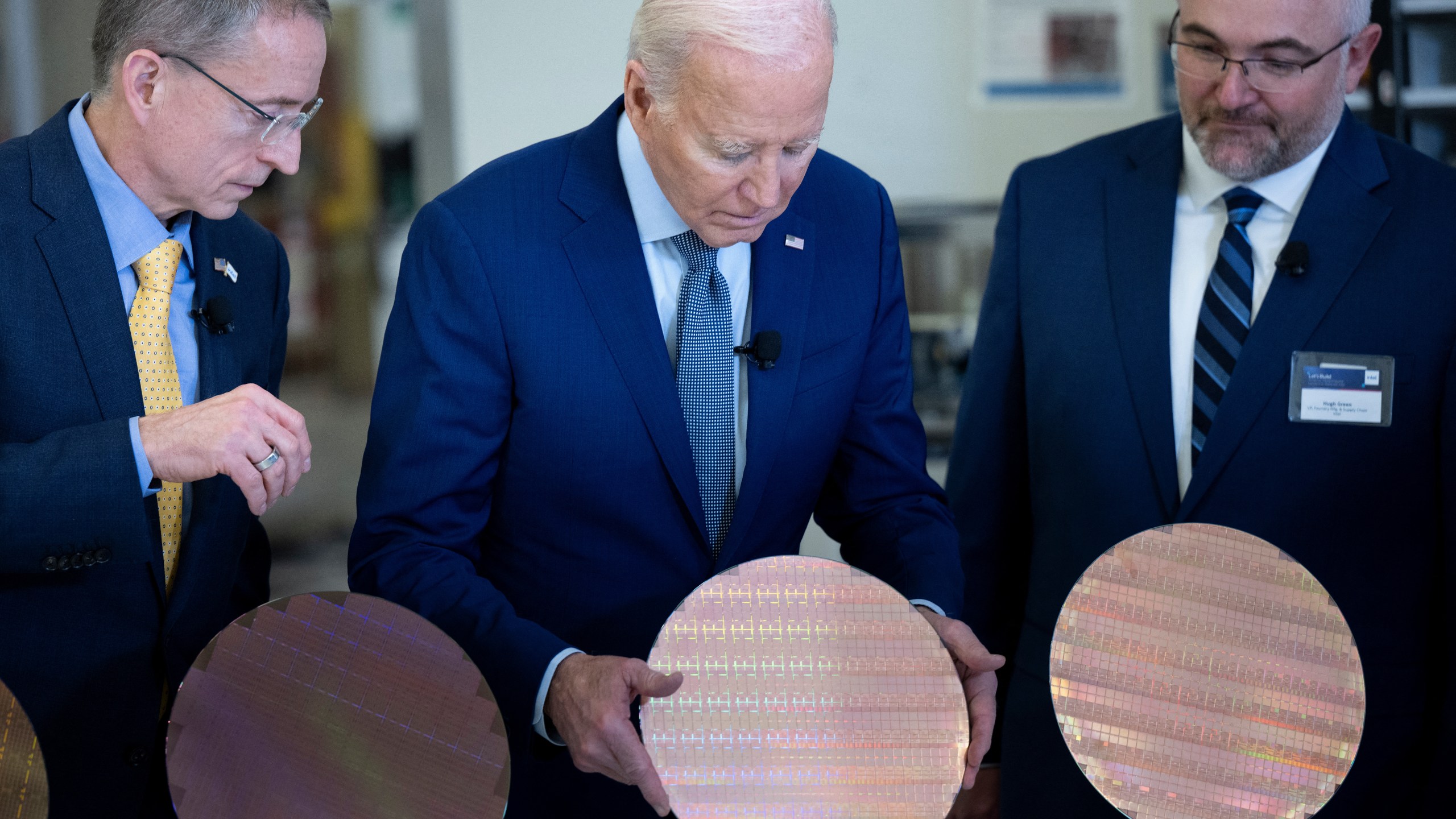 U.S. President Joe Biden looks at a semiconductor wafer during a tour at Intel Ocotillo Campus in Chandler, Arizona, on March 20th, 2024.