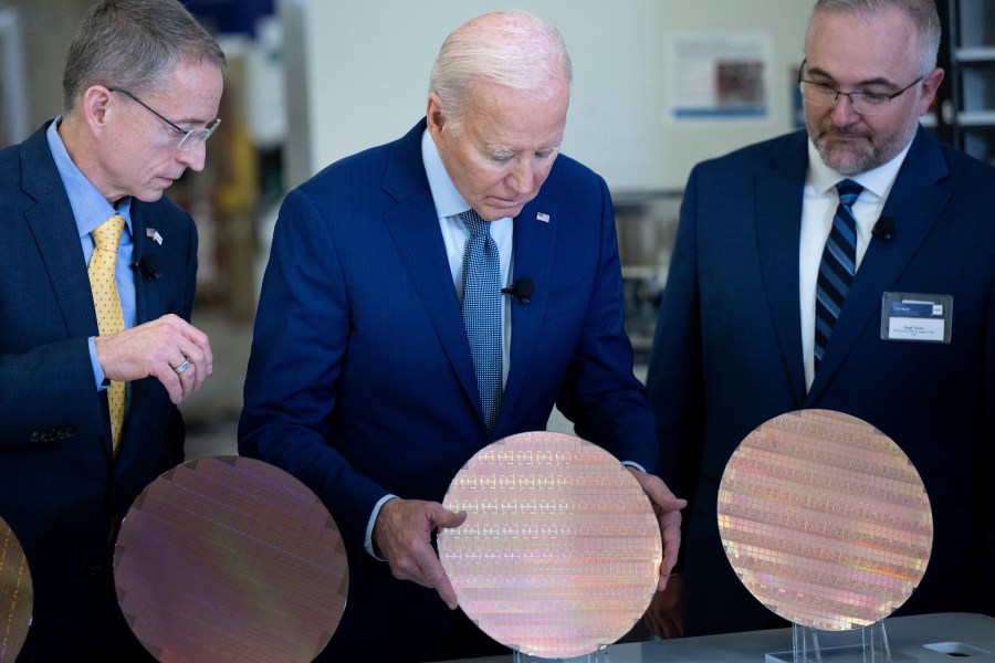 U.S. President Joe Biden looks at a semiconductor wafer during a tour at Intel Ocotillo Campus in Chandler, Arizona, on March 20th, 2024.