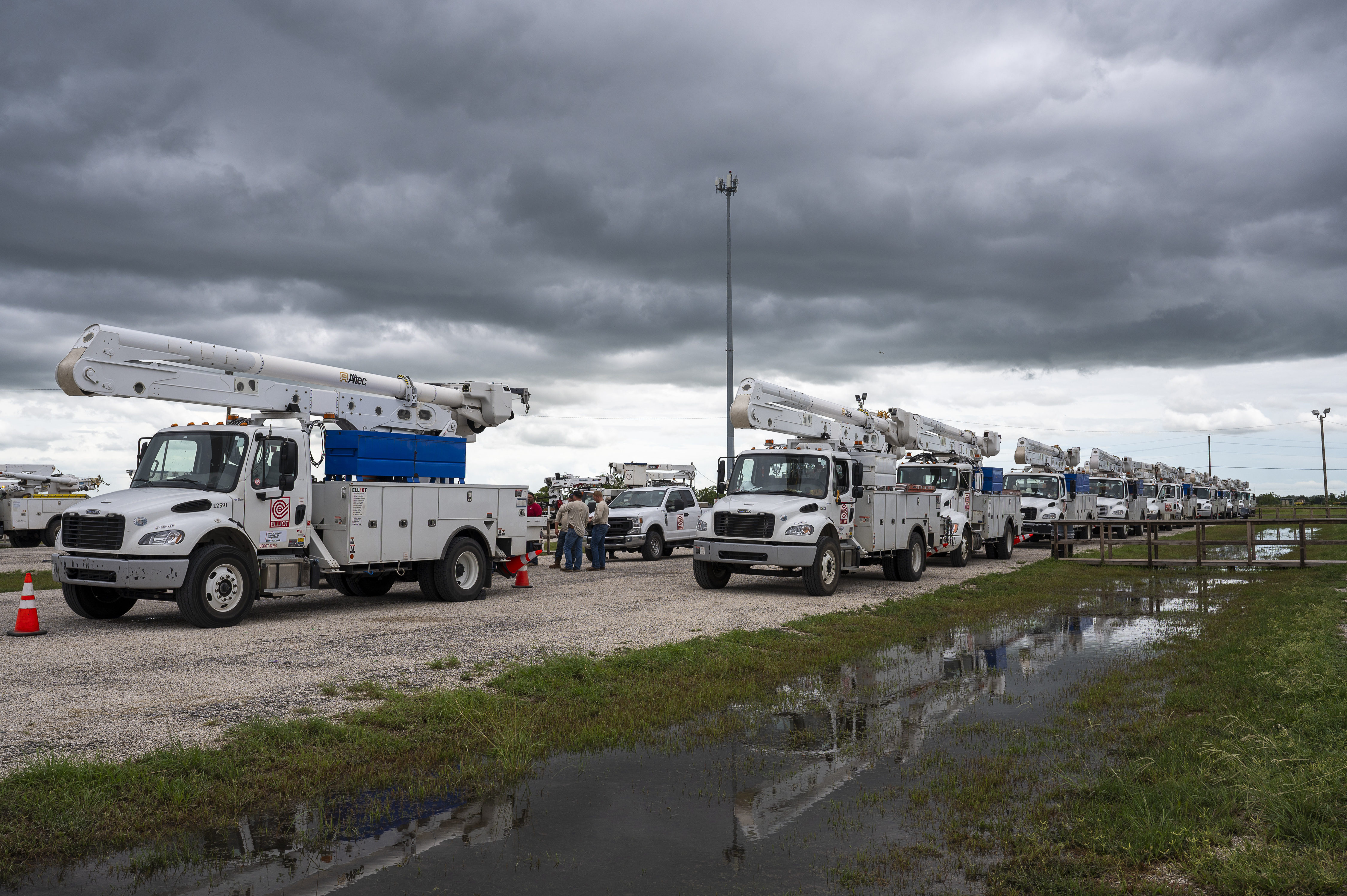 Power company service vehicles gather after Hurricane Beryl made landfall near Bay City, Texas, US, on Monday, July 8, 2024.