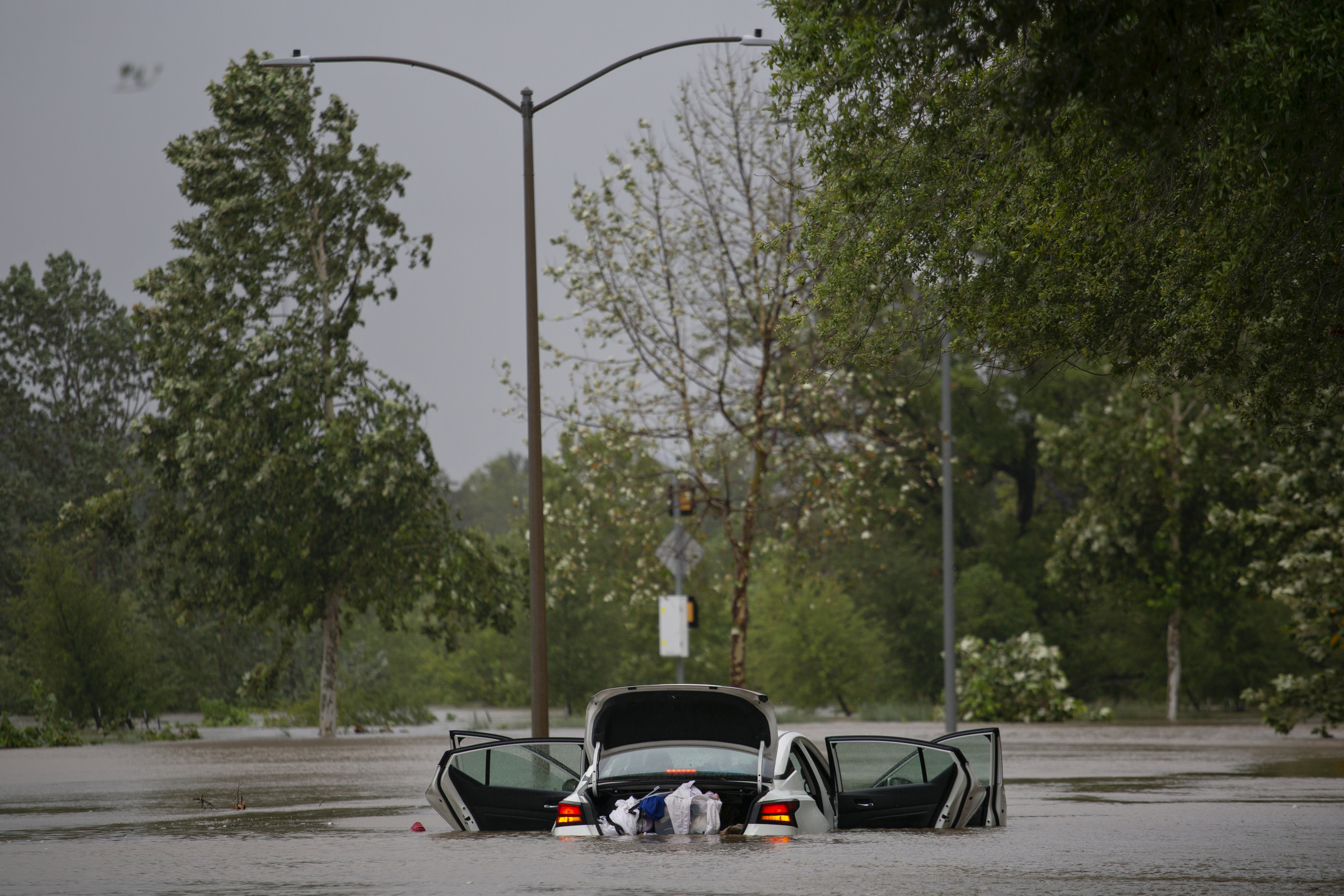 An abandoned car flooded in high flood water along Allen Parkway in Houston, Texas on July 8, 2024.