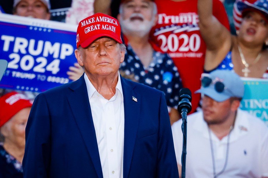 Donald Trump in a MAGA hat at a campaign event