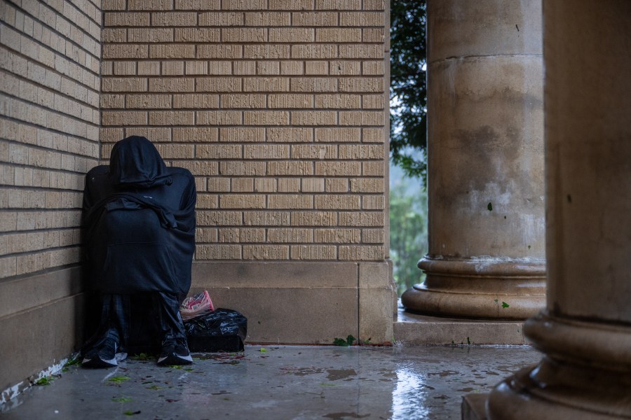 A person attempts to keep warm under shelter during Hurricane Beryl on July 08, 2024 in Houston, Texas. 