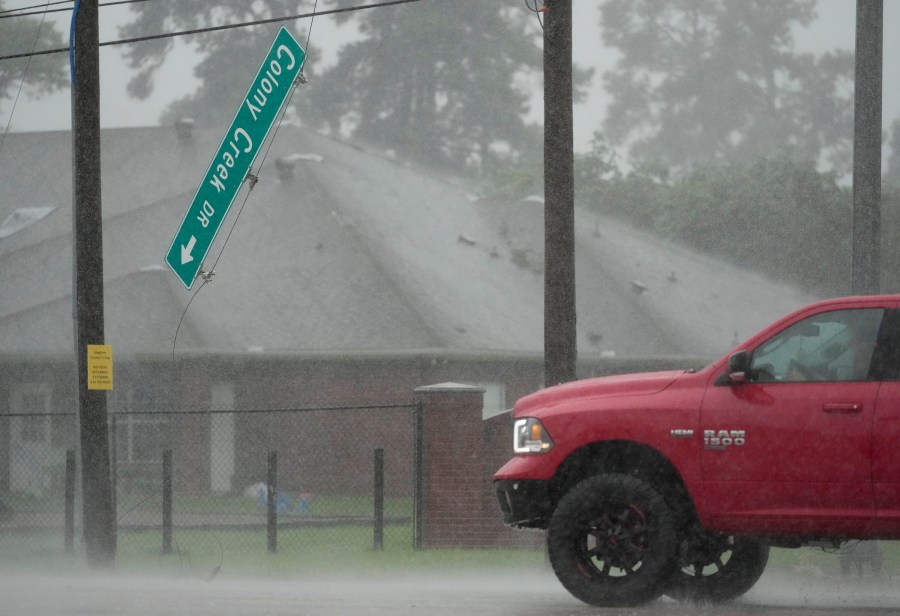 The Colony Creek Dr. street sign dangles at the intersection of Louetta Rd.  during Hurricane Beryl Monday, July 8, 2024, in Spring. 