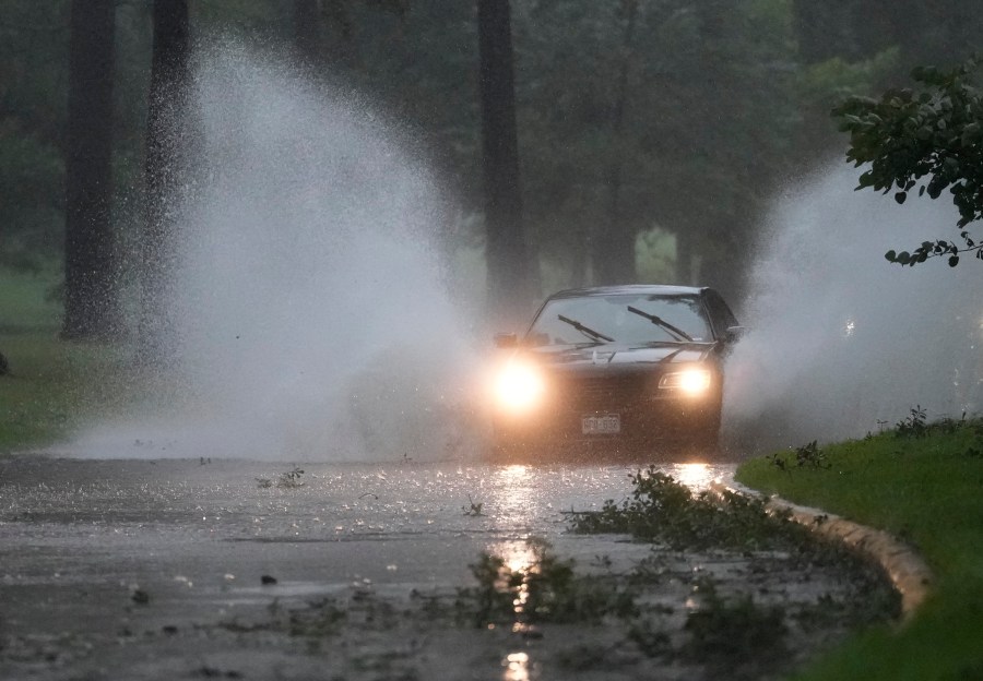 A vehicle maneuvers through high water and debris on Cypresswood Dr. during Hurricane Beryl Monday, July 8, 2024, in Spring.