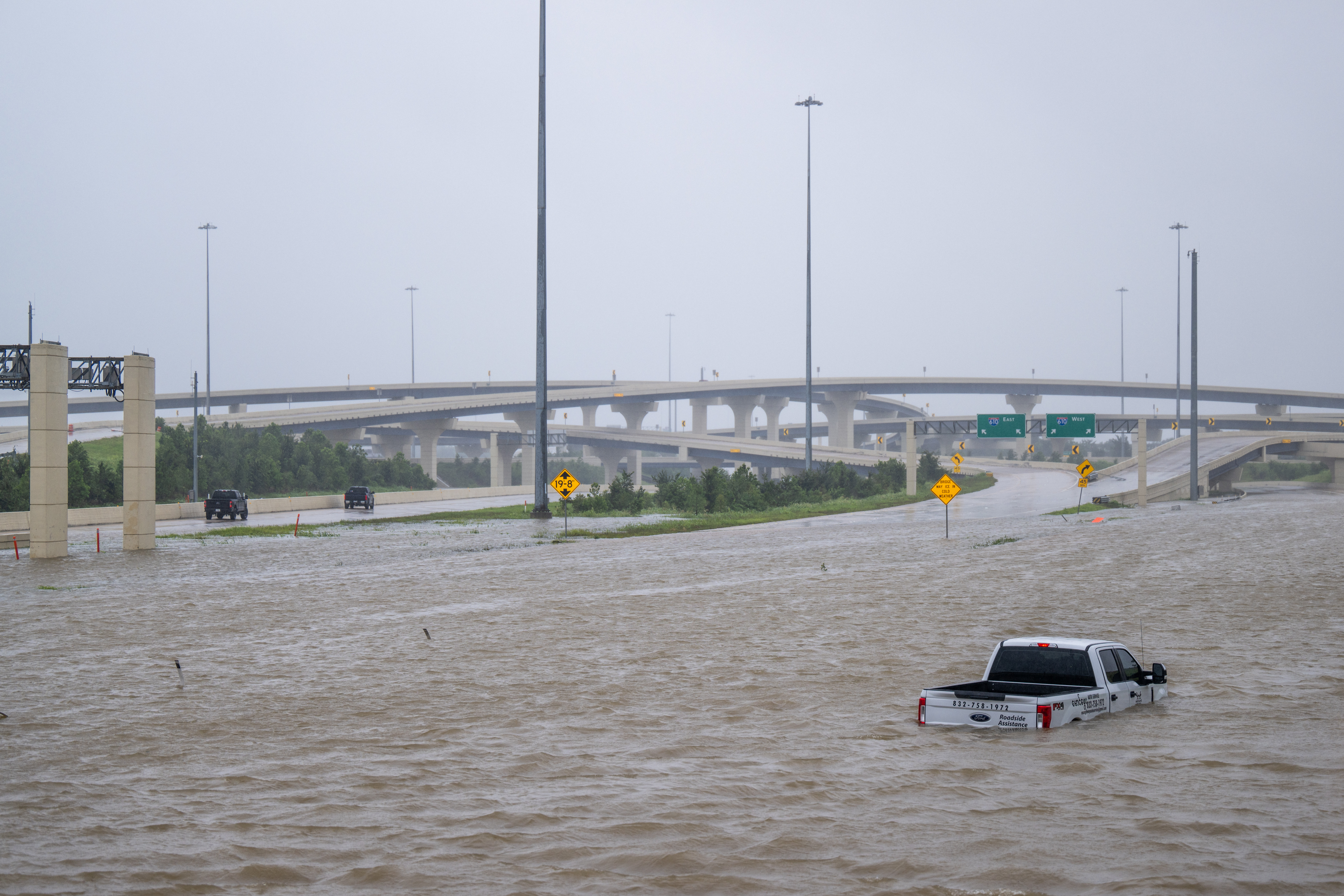 A vehicle is left abandoned in floodwater on a highway after Hurricane Beryl swept through the area on July 08, 2024 in Houston, Texas.