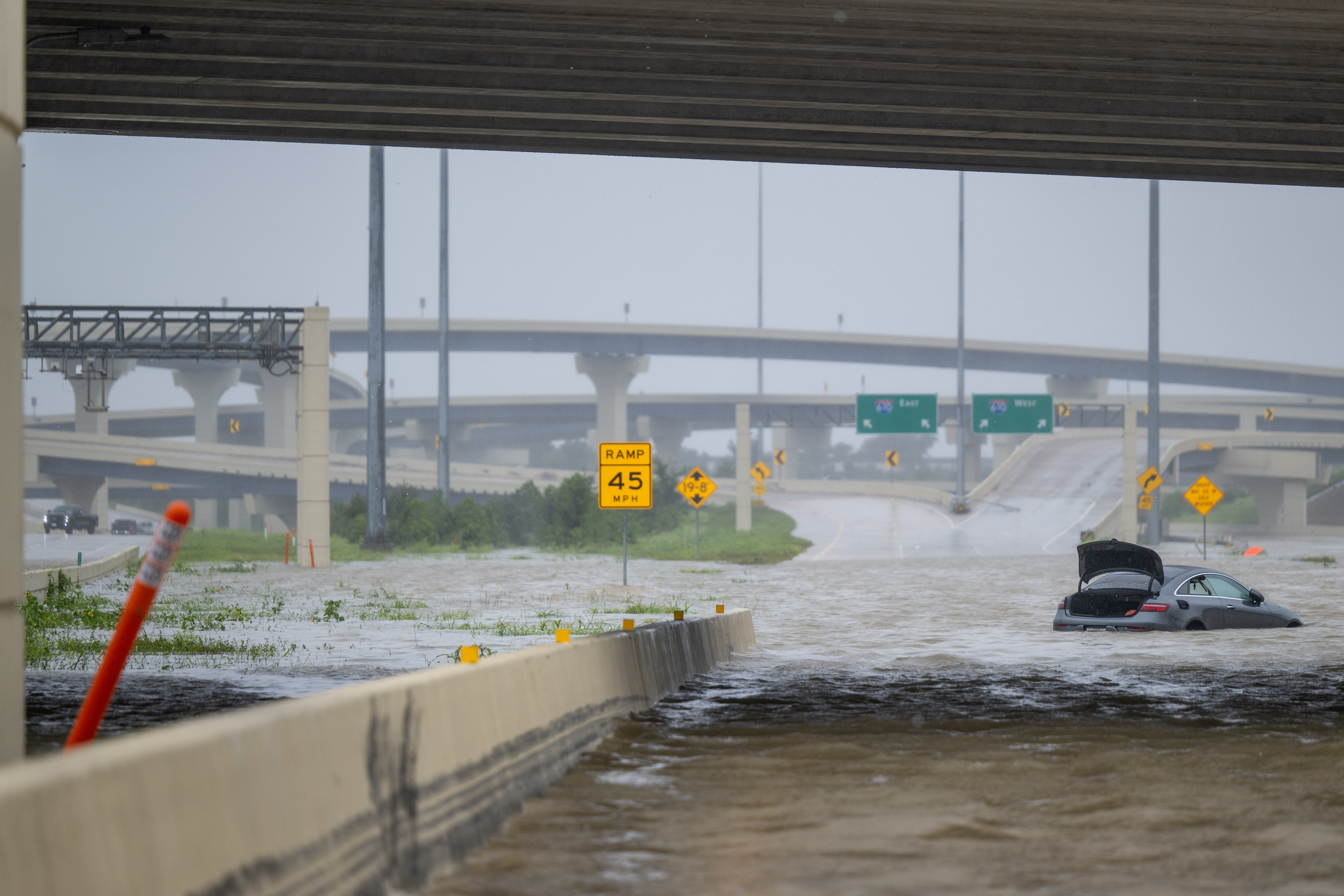 A vehicle is left abandoned in floodwater on a highway after Hurricane Beryl swept through the area on July 08, 2024 in Houston, Texas.