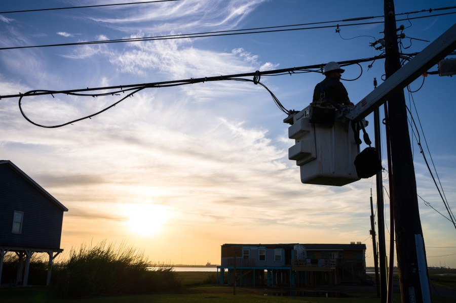 A utility worker works to restore a damaged power-line after Hurricane Beryl swept through the area on July 08, 2024 in Surfside, Texas.