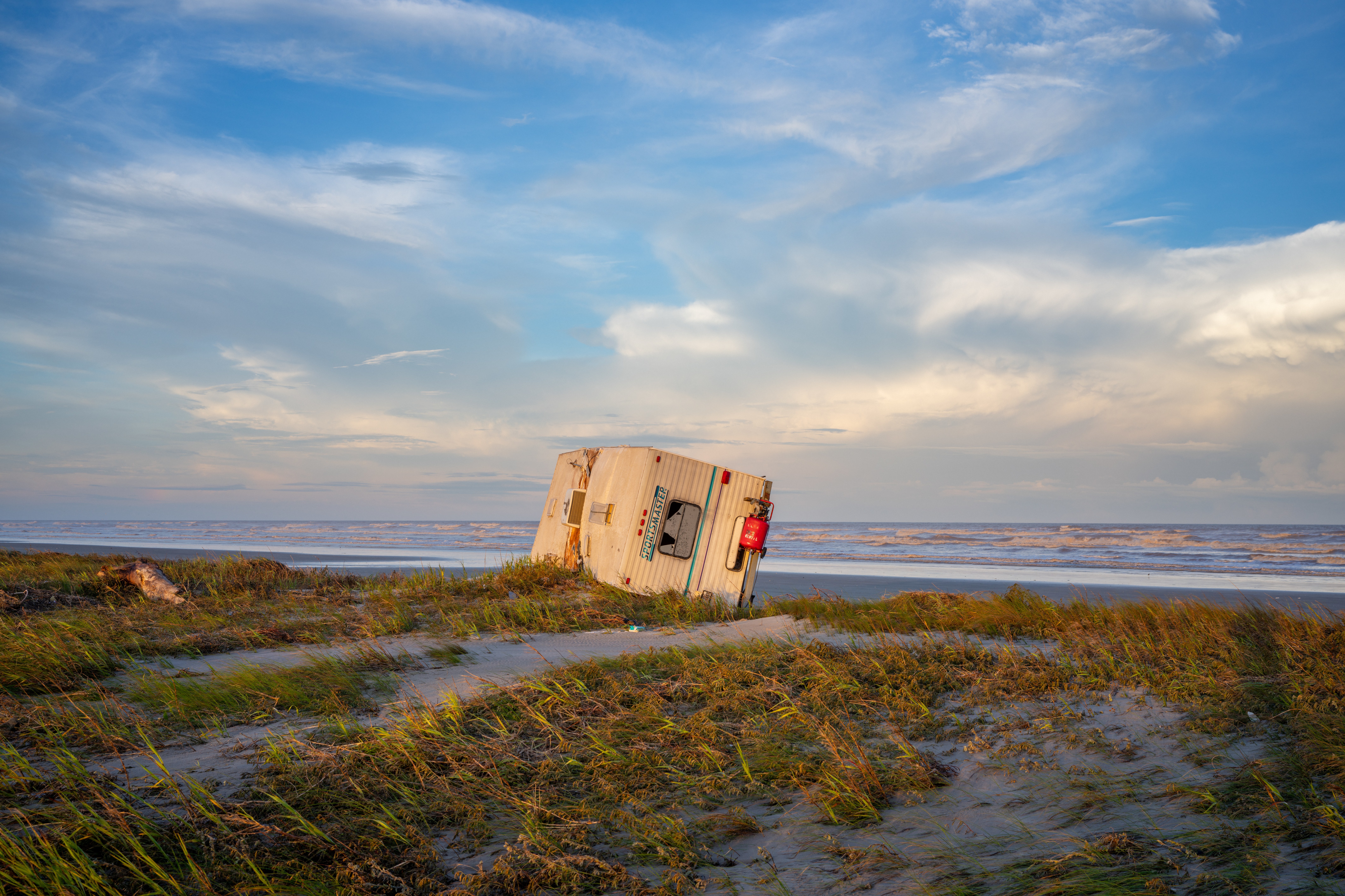 A mobile home is collapsed over on shore after Hurricane Beryl swept through the area on July 08, 2024 in Freeport, Texas.