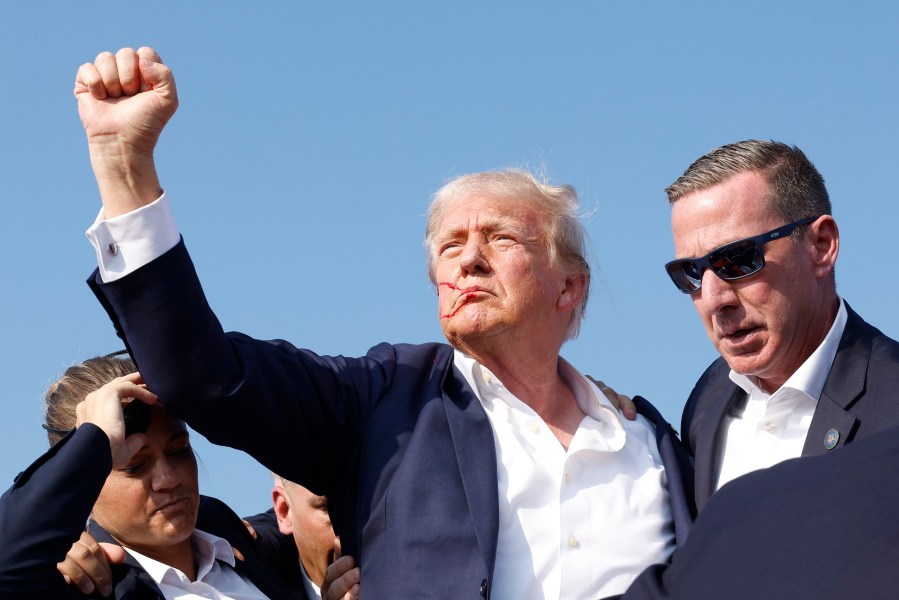 Former President Donald Trump is rushed offstage during a rally on July 13, 2024 in Butler, Pennsylvania.