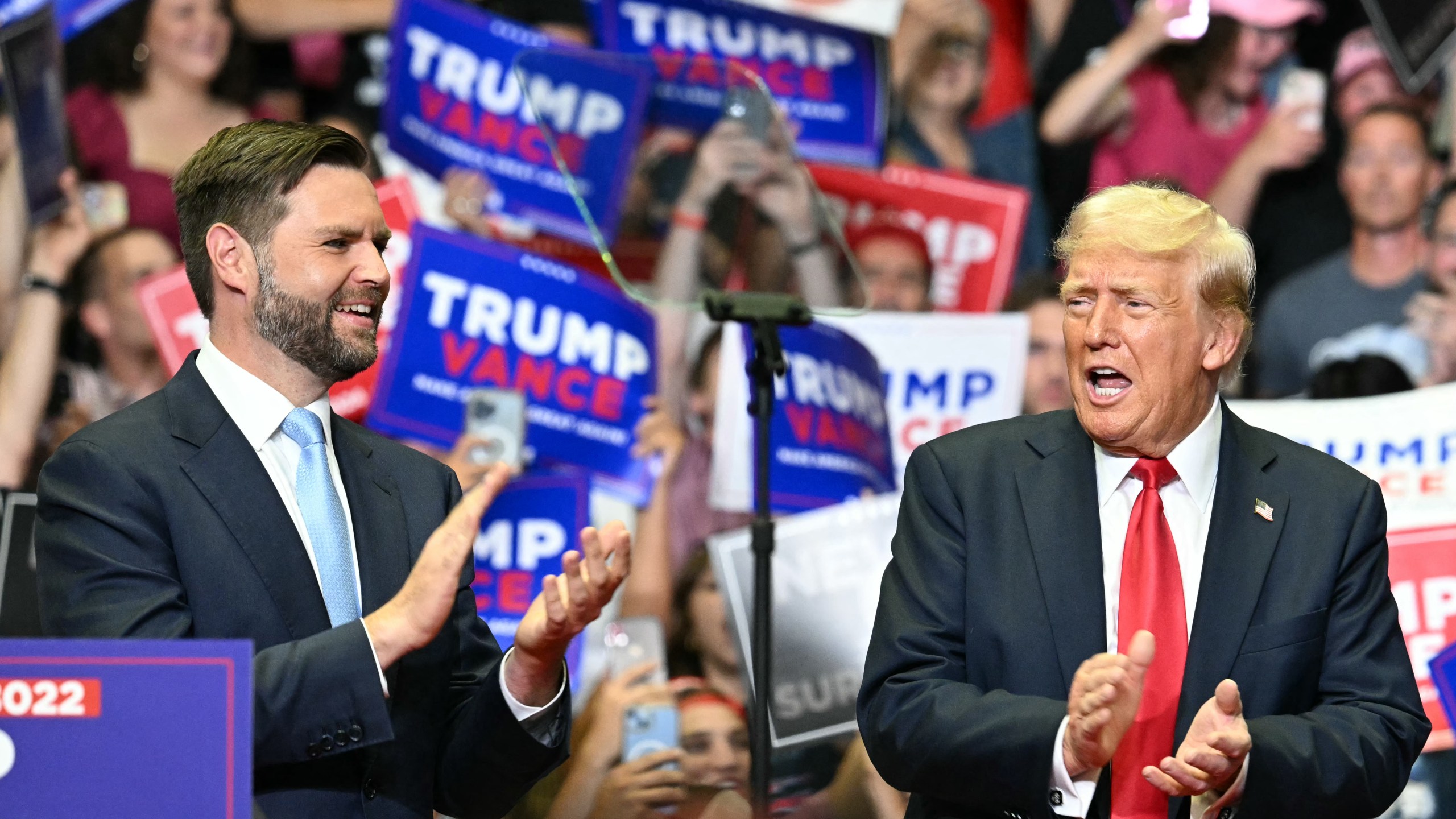 Donald Trump and JD Vance clap at a Grand Rapids, Michigan, rally on July 20, 2024.